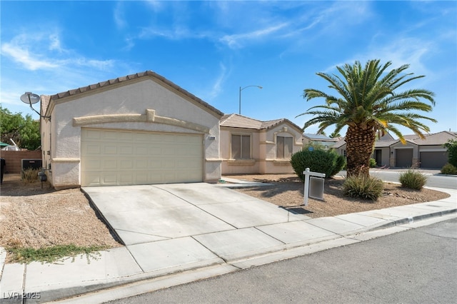 3108 Sentimental Ct, North Las Vegas, NV 89031 - view of front facade featuring stucco siding, driveway, a garage, and a tiled roof