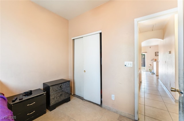 3108 Sentimental Ct, North Las Vegas, NV 89031 - bedroom featuring light tile patterned floors, arched walkways, and a closet