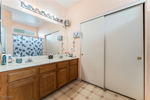 3108 Sentimental Ct, North Las Vegas, NV 89031 - bathroom featuring tile patterned floors, double vanity, and curtained shower