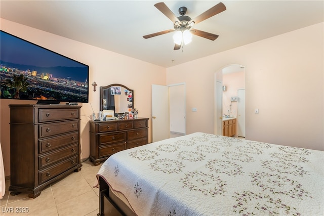 3108 Sentimental Ct, North Las Vegas, NV 89031 - bedroom featuring light tile patterned floors, arched walkways, and a ceiling fan