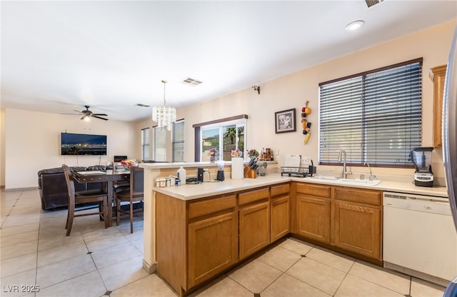 3108 Sentimental Ct, North Las Vegas, NV 89031 - kitchen with dishwasher, a peninsula, open floor plan, a chandelier, and light countertops