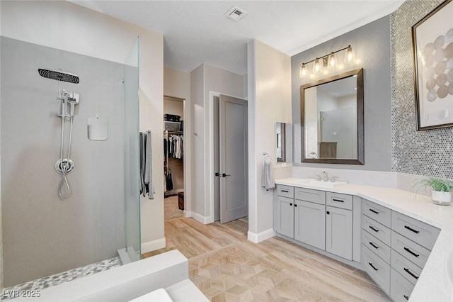 2333 Indigo Island St, Henderson, NV 89044 - full bathroom with a walk in shower, vanity, wood finished floors, and a walk in closet