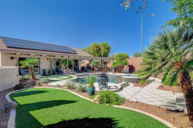 2333 Indigo Island St, Henderson, NV 89044 - fenced backyard with a patio, a pool with connected hot tub, and an area to practice putting