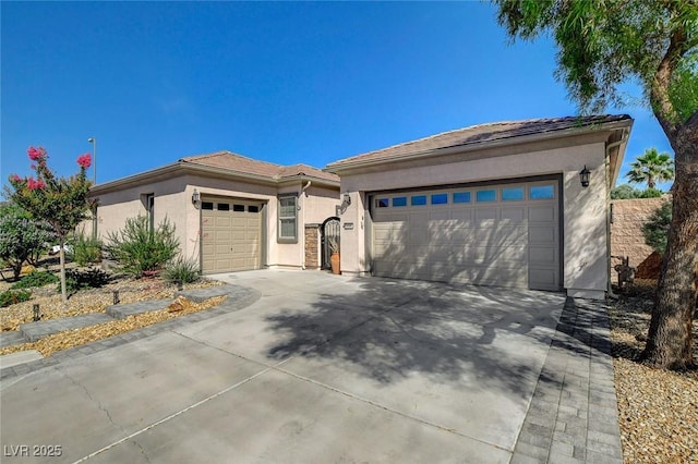 2333 Indigo Island St, Henderson, NV 89044 - view of front of home with a garage, stucco siding, and driveway
