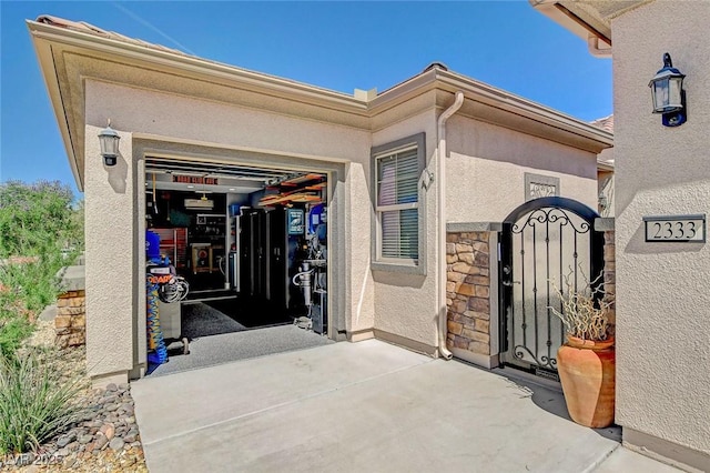 2333 Indigo Island St, Henderson, NV 89044 - view of exterior entry with stone siding, stucco siding, and a gate
