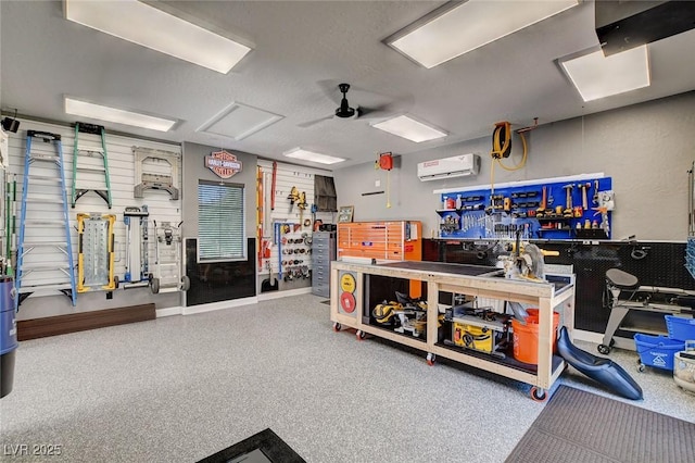 2333 Indigo Island St, Henderson, NV 89044 - miscellaneous room with a workshop area, a wall unit AC, speckled floor, and a ceiling fan
