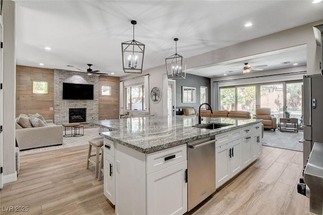 2333 Indigo Island St, Henderson, NV 89044 - kitchen featuring open floor plan, ceiling fan, appliances with stainless steel finishes, recessed lighting, and a brick fireplace