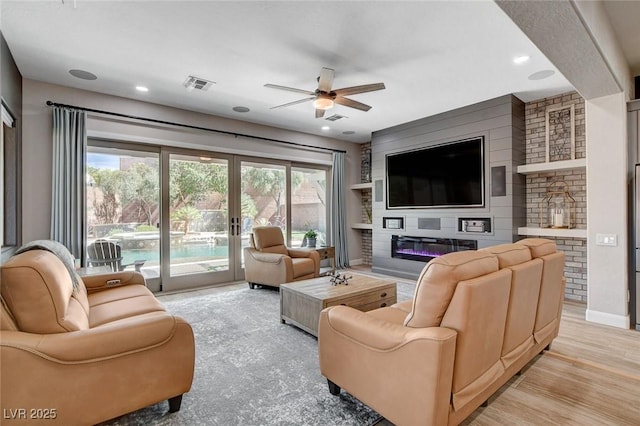 2333 Indigo Island St, Henderson, NV 89044 - living room featuring ceiling fan, healthy amount of natural light, french doors, a glass covered fireplace, and recessed lighting