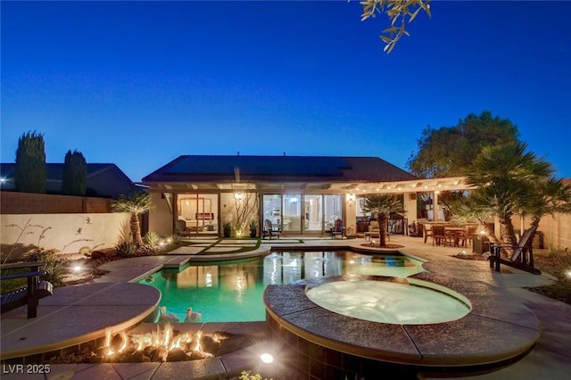 2333 Indigo Island St, Henderson, NV 89044 - pool at twilight with a pool with connected hot tub, a patio area, and exterior bar