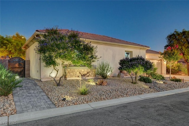 2333 Indigo Island St, Henderson, NV 89044 - view of front facade with stucco siding and a garage