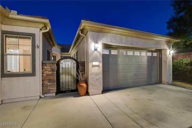 2333 Indigo Island St, Henderson, NV 89044 - view of front of property featuring stucco siding, stone siding, concrete driveway, a gate, and an attached garage