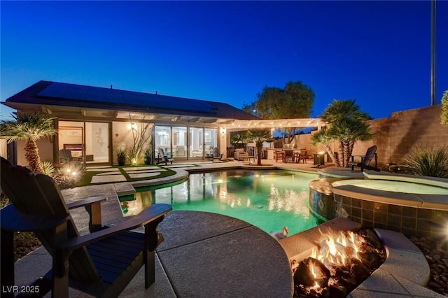 2333 Indigo Island St, Henderson, NV 89044 - pool at twilight featuring a fire pit, an outdoor bar, a patio, and a pool with connected hot tub