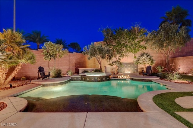2333 Indigo Island St, Henderson, NV 89044 - pool at twilight featuring a fenced backyard, a patio, and a pool with connected hot tub