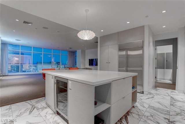 4575 Dean Martin Dr Unit 2607, Las Vegas, NV 89103 - kitchen with wine cooler, modern cabinets, built in fridge, light marble finish flooring, and light countertops