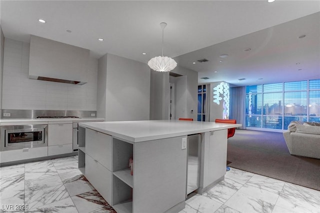 4575 Dean Martin Dr Unit 2607, Las Vegas, NV 89103 - kitchen with modern cabinets, light marble finish flooring, open floor plan, wall oven, and light countertops