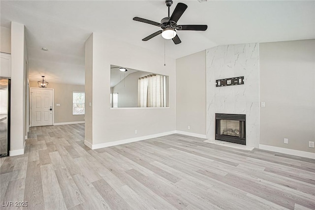 9514 Teton Vista Ave, Las Vegas, NV 89117 - unfurnished living room with light wood finished floors, ceiling fan, a premium fireplace, and lofted ceiling