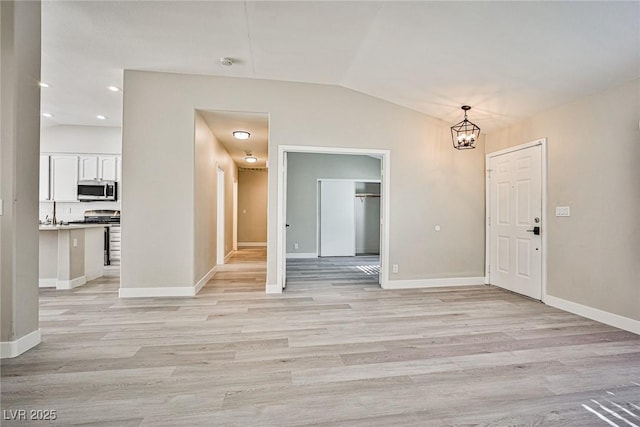 9514 Teton Vista Ave, Las Vegas, NV 89117 - unfurnished dining area featuring vaulted ceiling, a chandelier, light wood-type flooring, and recessed lighting