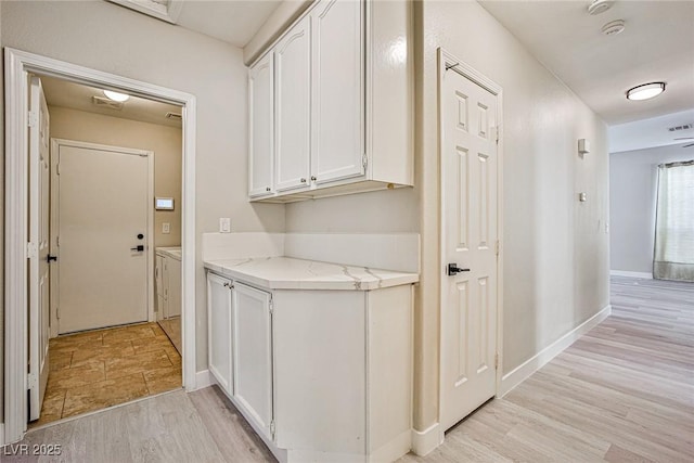 9514 Teton Vista Ave, Las Vegas, NV 89117 - laundry area featuring light wood-style floors and baseboards