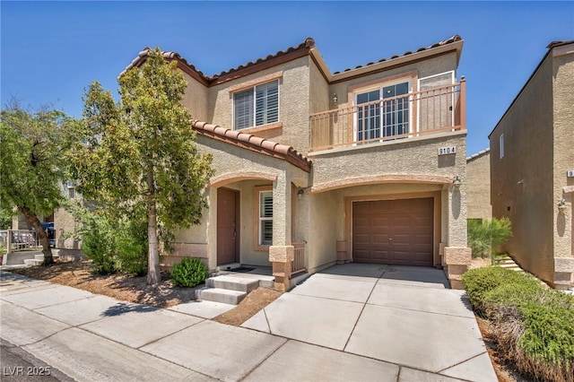9104 Pearl Cotton Ave, Las Vegas, NV 89149 - view of front of home featuring a balcony, a tiled roof, an attached garage, driveway, and stucco siding