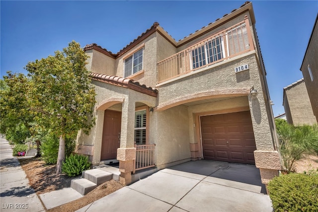 9104 Pearl Cotton Ave, Las Vegas, NV 89149 - view of front of home featuring a tile roof, stucco siding, driveway, a balcony, and a garage