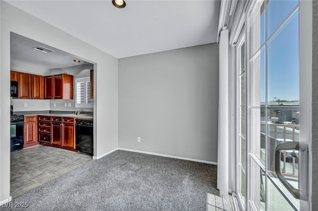 9104 Pearl Cotton Ave, Las Vegas, NV 89149 - kitchen with black appliances, reddish brown cabinets, and light carpet