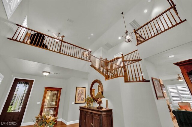 326 Caneflower Ct, North Las Vegas, NV 89031 - stairs featuring a high ceiling, ceiling fan, healthy amount of natural light, a chandelier, and recessed lighting