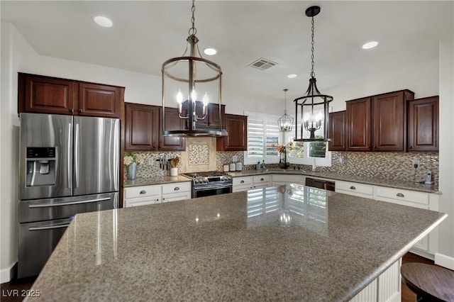 326 Caneflower Ct, North Las Vegas, NV 89031 - kitchen with stainless steel appliances, a chandelier, under cabinet range hood, recessed lighting, and tasteful backsplash