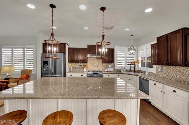 326 Caneflower Ct, North Las Vegas, NV 89031 - kitchen featuring stainless steel appliances, plenty of natural light, backsplash, a center island, and recessed lighting
