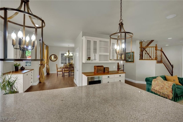 326 Caneflower Ct, North Las Vegas, NV 89031 - dining space with a chandelier, dark wood-style floors, beverage cooler, recessed lighting, and stairs