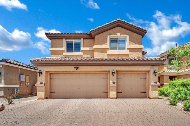 326 Caneflower Ct, North Las Vegas, NV 89031 - view of front of house with an attached garage, decorative driveway, stucco siding, and a tiled roof