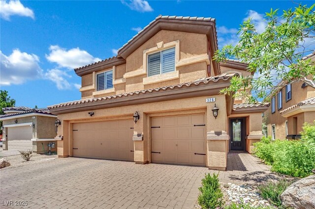 326 Caneflower Ct, North Las Vegas, NV 89031 - view of front of house featuring stucco siding, decorative driveway, a tiled roof, and a garage