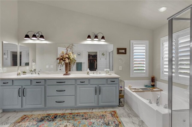 326 Caneflower Ct, North Las Vegas, NV 89031 - full bathroom featuring marble finish floors, lofted ceiling, double vanity, and a garden tub
