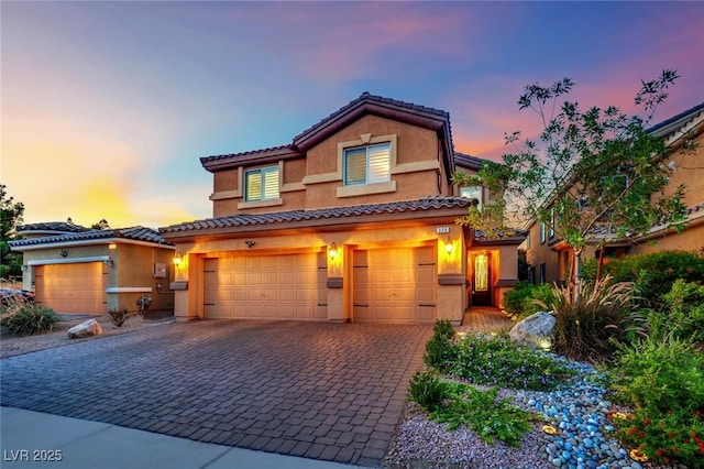326 Caneflower Ct, North Las Vegas, NV 89031 - view of front facade featuring an attached garage, decorative driveway, stucco siding, and a tile roof