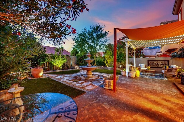 326 Caneflower Ct, North Las Vegas, NV 89031 - patio terrace at dusk featuring a patio area, a fenced backyard, a pergola, and outdoor lounge area
