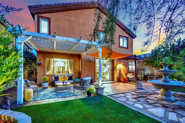 326 Caneflower Ct, North Las Vegas, NV 89031 - back of house featuring a patio area, stucco siding, and an outdoor living space
