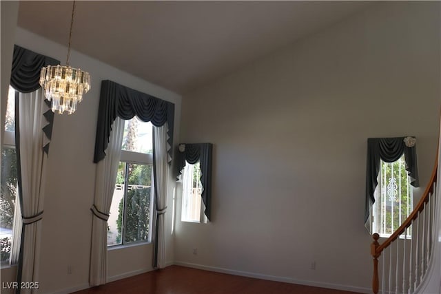 8982 Emerald Waters Ct, Las Vegas, NV 89147 - unfurnished room featuring a chandelier, wood finished floors, and lofted ceiling