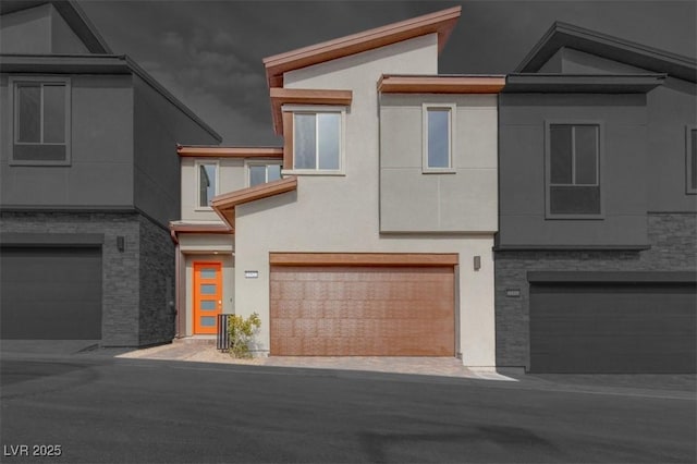 11922 Glide Reflection Ave, Las Vegas, NV 89138 - view of front of house featuring an attached garage and stucco siding