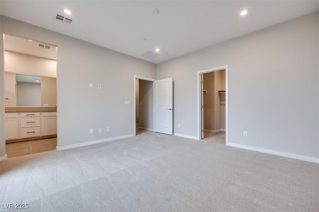 11922 Glide Reflection Ave, Las Vegas, NV 89138 - unfurnished bedroom featuring light carpet, a spacious closet, ensuite bathroom, and recessed lighting