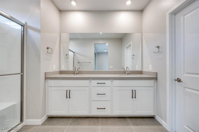 11922 Glide Reflection Ave, Las Vegas, NV 89138 - bathroom featuring double vanity, a shower stall, tile patterned flooring, and recessed lighting