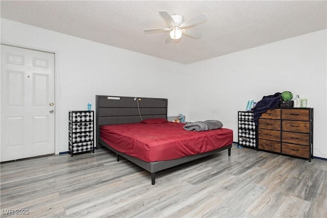 4232 Park Ct, Las Vegas, NV 89110 - bedroom featuring wood finished floors, a textured ceiling, and ceiling fan
