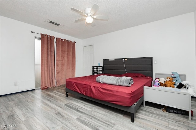4232 Park Ct, Las Vegas, NV 89110 - bedroom with wood finished floors, a textured ceiling, and ceiling fan