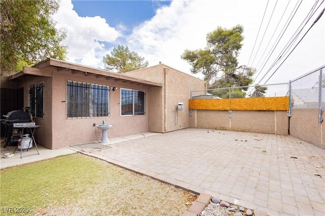4232 Park Ct, Las Vegas, NV 89110 - rear view of property featuring stucco siding and a patio area