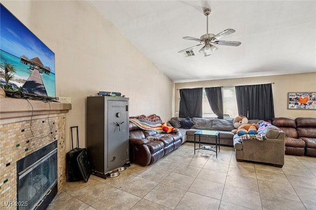 2716 Orchid Moon Ct, North Las Vegas, NV 89031 - living area featuring vaulted ceiling, a ceiling fan, light tile patterned flooring, and a fireplace