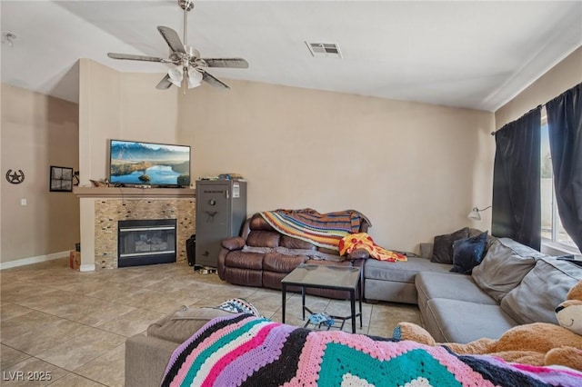 2716 Orchid Moon Ct, North Las Vegas, NV 89031 - tiled living room with ceiling fan and a tiled fireplace
