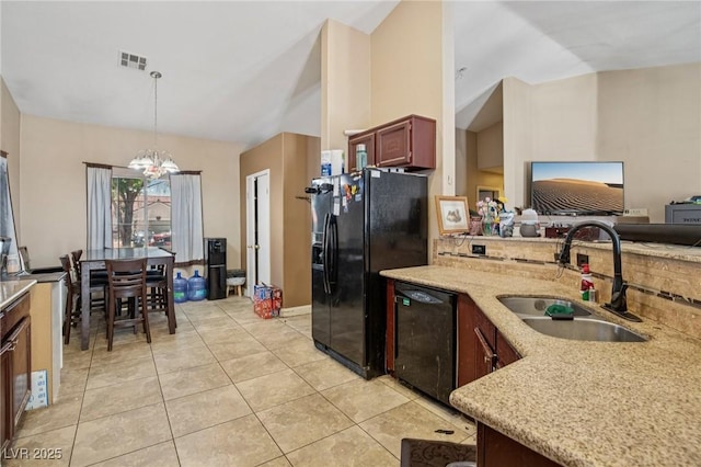 2716 Orchid Moon Ct, North Las Vegas, NV 89031 - kitchen featuring black appliances, vaulted ceiling, light stone countertops, hanging light fixtures, and light tile patterned floors