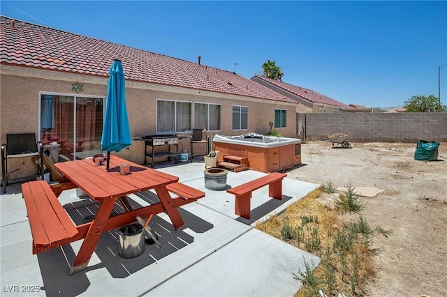 2716 Orchid Moon Ct, North Las Vegas, NV 89031 - fenced backyard with a hot tub, a patio, outdoor dining area, and a fire pit