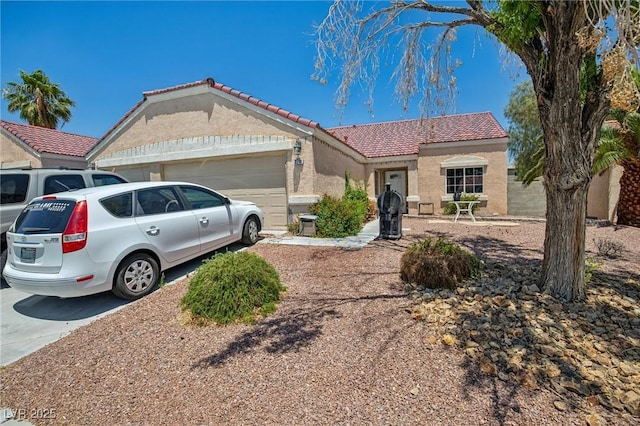 2716 Orchid Moon Ct, North Las Vegas, NV 89031 - view of front of house featuring an attached garage, a tile roof, stucco siding, and driveway
