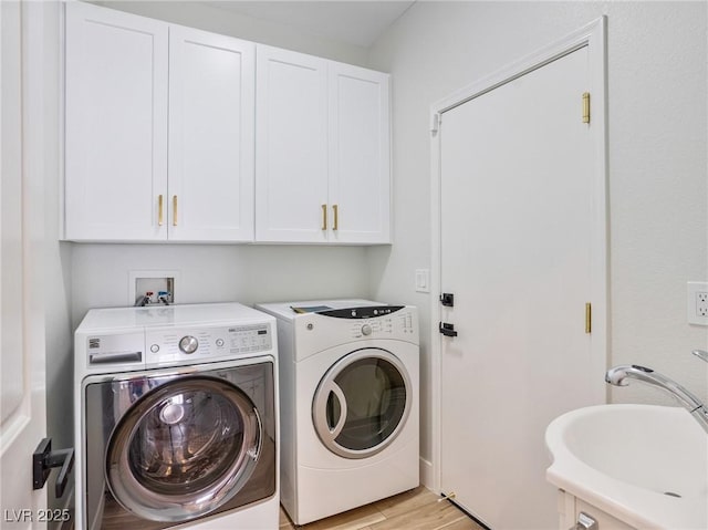 4314 Livorno Ave, Las Vegas, NV 89141 - laundry area with separate washer and dryer, cabinet space, and light wood-style flooring