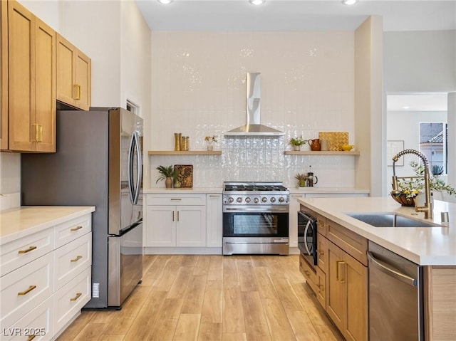 4314 Livorno Ave, Las Vegas, NV 89141 - kitchen featuring wall chimney exhaust hood, stainless steel appliances, light wood-type flooring, light countertops, and backsplash