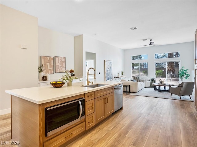 4314 Livorno Ave, Las Vegas, NV 89141 - kitchen with appliances with stainless steel finishes, a ceiling fan, light countertops, and open floor plan